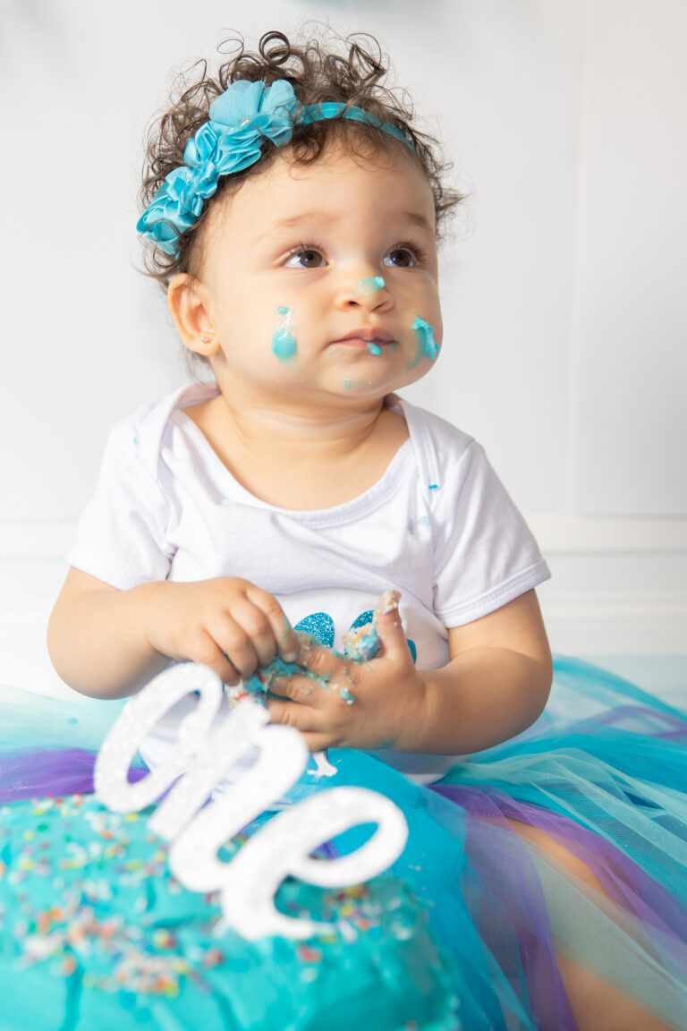 one year old girl at her cake smash session