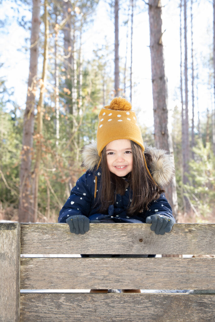 young girl smiling dressed in winter clothes